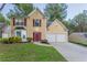 Charming two-story home with a well-manicured lawn, two-car garage, and inviting red front door at 7113 Ambercrest Ct, Austell, GA 30168