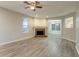 Open-concept living room featuring light gray flooring, fireplace, and windows providing natural light at 7113 Ambercrest Ct, Austell, GA 30168