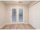 Bright room featuring wood floors, French doors leading outside, and a white closet at 7113 Ambercrest Ct, Austell, GA 30168