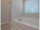Bright bathroom showcases a tub with chrome faucet and a shower with glass door at 16 Deer Place, Villa Rica, GA 30180