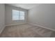 Well-lit bedroom with large window and neutral colored carpet at 16 Deer Place, Villa Rica, GA 30180
