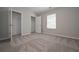 Carpeted bedroom with windows and an open closet with wire shelving at 16 Deer Place, Villa Rica, GA 30180