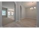 Bright dining room with wood floors, archway, and stylish chandelier at 16 Deer Place, Villa Rica, GA 30180