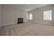 Spacious living room with fireplace and neutral carpet, complemented by natural light streaming through two windows at 16 Deer Place, Villa Rica, GA 30180