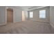 Bright main bedroom with dual windows, closet space, and neutral-toned carpet creates a relaxing atmosphere at 16 Deer Place, Villa Rica, GA 30180