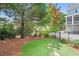 Well-maintained backyard featuring artificial turf, mature trees, and a wrought iron fence at 1974 Mason Mill Rd, Decatur, GA 30033