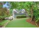 Beautiful backyard featuring artificial turf, patio, and a charming two-story house at 1974 Mason Mill Rd, Decatur, GA 30033