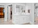 Bathroom with a large mirror over the vanity and entrances to a closet and another room at 1974 Mason Mill Rd, Decatur, GA 30033