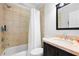Well-lit bathroom featuring a shower-tub combo, sleek fixtures, and elegant tile work at 1974 Mason Mill Rd, Decatur, GA 30033