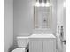 This half bath has a white vanity and a framed mirror above it at 1974 Mason Mill Rd, Decatur, GA 30033