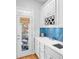 Elegant butler's pantry featuring white cabinets, blue tile backsplash, and wine rack at 1974 Mason Mill Rd, Decatur, GA 30033