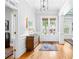 Bright entryway with hardwood floors, classic wainscoting, and a view to the front doors at 1974 Mason Mill Rd, Decatur, GA 30033