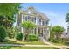 Traditional two-story home with gray siding, black shutters, mature landscaping, and covered front porch at 1974 Mason Mill Rd, Decatur, GA 30033