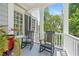 Inviting front porch featuring rocking chairs, white columns, and a view of the landscaped yard at 1974 Mason Mill Rd, Decatur, GA 30033