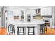Bright kitchen features white cabinets, a stainless steel dual oven, and an expansive center island with barstool seating at 1974 Mason Mill Rd, Decatur, GA 30033