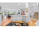 Bright, open kitchen with a center island, stainless appliances, and hardwood floors that flow into the dining and living areas at 1974 Mason Mill Rd, Decatur, GA 30033