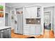 This area of the kitchen features a stainless refrigerator and white cabinets, and offers a view into another room at 1974 Mason Mill Rd, Decatur, GA 30033