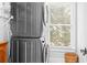 Laundry room with stacked washer and dryer and a window at 1974 Mason Mill Rd, Decatur, GA 30033