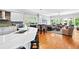 Open concept kitchen and living room featuring hardwood floors, a center island and stainless appliances in the modern kitchen at 1974 Mason Mill Rd, Decatur, GA 30033