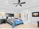 Main bedroom with ceiling fan, lamps, bedside tables, and ensuite bathroom at 1974 Mason Mill Rd, Decatur, GA 30033