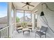 Cozy screened porch with comfortable seating, ceiling fan, and serene outdoor views at 1974 Mason Mill Rd, Decatur, GA 30033