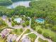 Beautiful aerial view of a community featuring a pool, tennis courts, and scenic landscaping at 6345 Sterling Shores Dr, Cumming, GA 30041