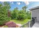 A lush backyard featuring professional landscaping, trees, and green grass at 6345 Sterling Shores Dr, Cumming, GA 30041