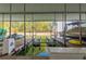 Covered boat dock featuring boat lifts, watercraft, and a view of the lake and trees at 6345 Sterling Shores Dr, Cumming, GA 30041