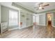 Bright bonus room featuring custom built-in shelving and wood-look flooring at 6345 Sterling Shores Dr, Cumming, GA 30041
