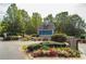 Welcoming entrance to St. Michaels Bay on Lake Lanier with colorful flowers and lush landscaping at 6345 Sterling Shores Dr, Cumming, GA 30041