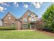 Beautiful brick and stone home featuring manicured lawn, professional landscaping and inviting front entrance at 6345 Sterling Shores Dr, Cumming, GA 30041