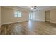 Spacious living room features tray ceiling, ceiling fan, wood floors, and sliding glass doors at 6345 Sterling Shores Dr, Cumming, GA 30041
