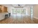 Large living room with tray ceiling, mini bar, wood floors, and a ceiling fan at 6345 Sterling Shores Dr, Cumming, GA 30041
