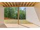 View of backyard featuring a covered patio and a spacious grassy area with mature trees along the perimeter at 6830 Heard Ln, Cumming, GA 30041