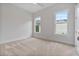 Spacious carpeted bedroom with two windows, filling the room with natural light at 6830 Heard Ln, Cumming, GA 30041