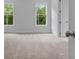 Bright bedroom with carpet, two large windows with view of the outside at 6830 Heard Ln, Cumming, GA 30041