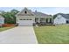 Charming single-Gathering home with a manicured lawn, attached garage, and inviting covered porch at 6830 Heard Ln, Cumming, GA 30041