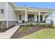Charming covered front porch with stone accents, decorative plants, and inviting entry door at 6830 Heard Ln, Cumming, GA 30041