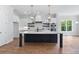 Modern kitchen with stainless steel appliances, a marble island, and open shelving at 6830 Heard Ln, Cumming, GA 30041