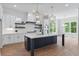Bright, modern kitchen with stainless steel appliances, a marble island, and a view of greenery at 6830 Heard Ln, Cumming, GA 30041