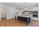 Modern kitchen with stainless steel appliances, a marble island, and stylish pendant lighting at 6830 Heard Ln, Cumming, GA 30041