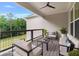 Inviting covered patio features comfortable seating and a ceiling fan, perfect for relaxing outdoors at 6830 Heard Ln, Cumming, GA 30041