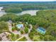 A stunning aerial view showcasing the community pool, tennis courts, and lush landscaping near a serene lake at , Cumming, GA 30041