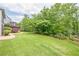 Expansive backyard with lush green lawn, mature trees, and tasteful landscaping, offering a private oasis at , Cumming, GA 30041