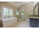Bathroom with a walk-in shower, soaking tub, large vanity and plantation shutters at , Cumming, GA 30041