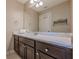 Bathroom featuring a dark vanity with a white marble countertop and large mirror at , Cumming, GA 30041