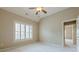 Cozy bedroom filled with neutral walls, large windows with shutters, and soft carpet flooring at , Cumming, GA 30041