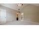 Spacious bedroom with vaulted ceiling, neutral carpeting, and open doorway to bathroom at , Cumming, GA 30041