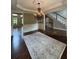 Formal dining room features a chandelier, hardwood floors, and classic wainscoting at , Cumming, GA 30041
