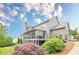 Lovely home exterior with multi-level deck, screened in porch, and a beautifully landscaped yard with mature plantings at , Cumming, GA 30041